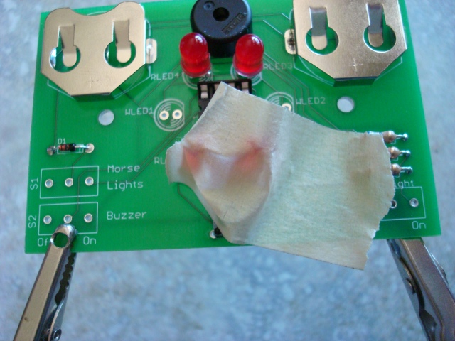 A picture of the taped button.